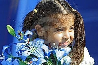 girl holding blue flowers thumb4057852