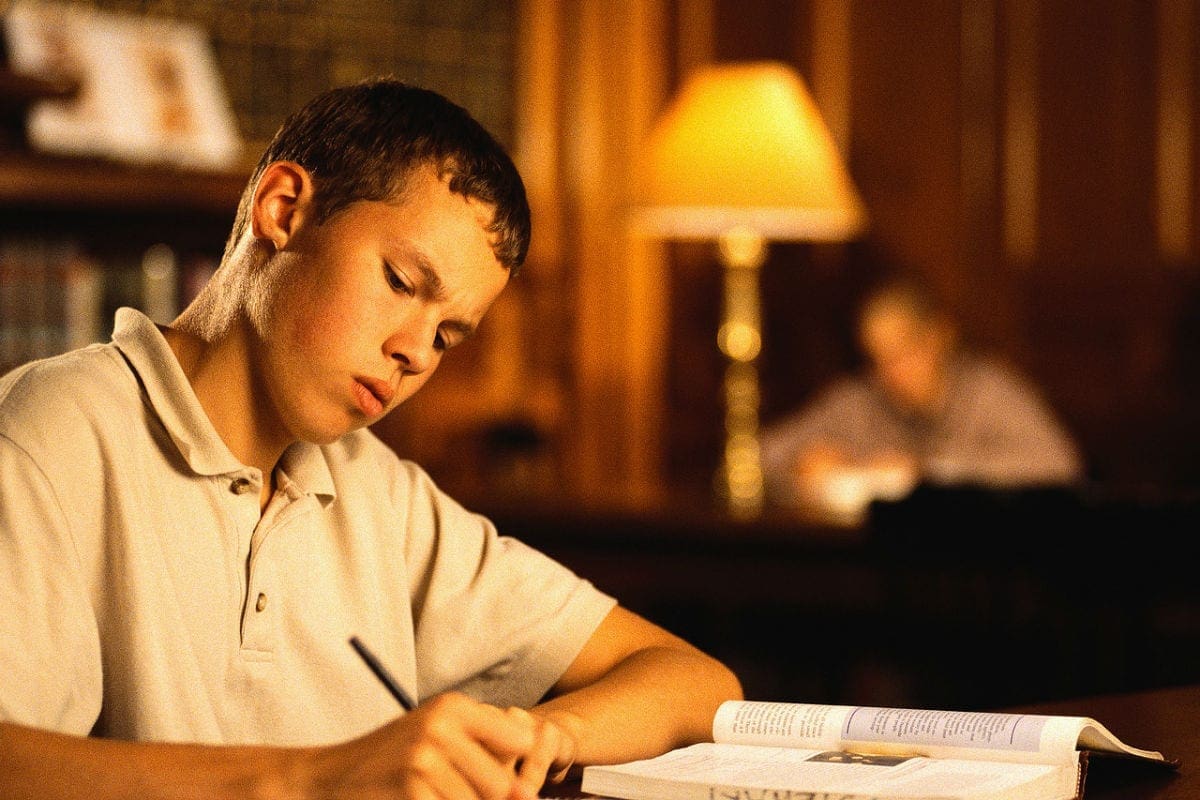 College Student Studying in Library