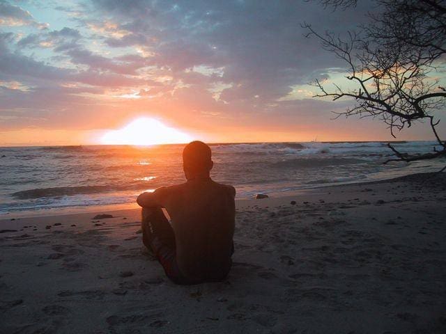Man watching the sunset on the beach in Mal Pais 2