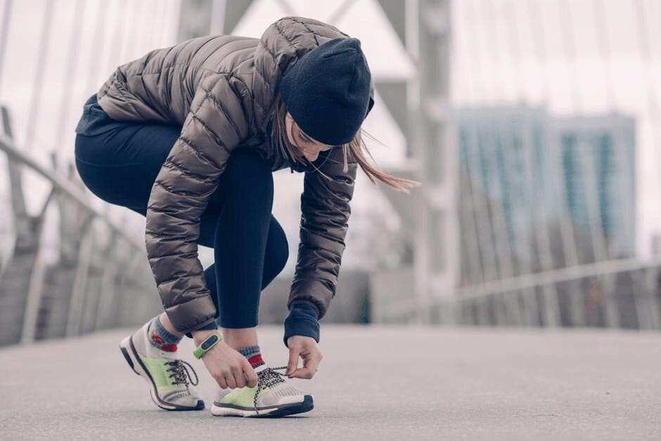 Exercise lady tying her shoes