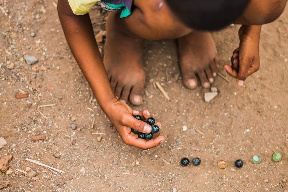 child playing marbles