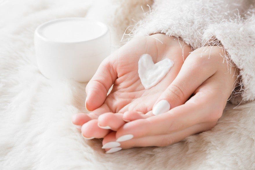 Female hands with moisturiser heart
