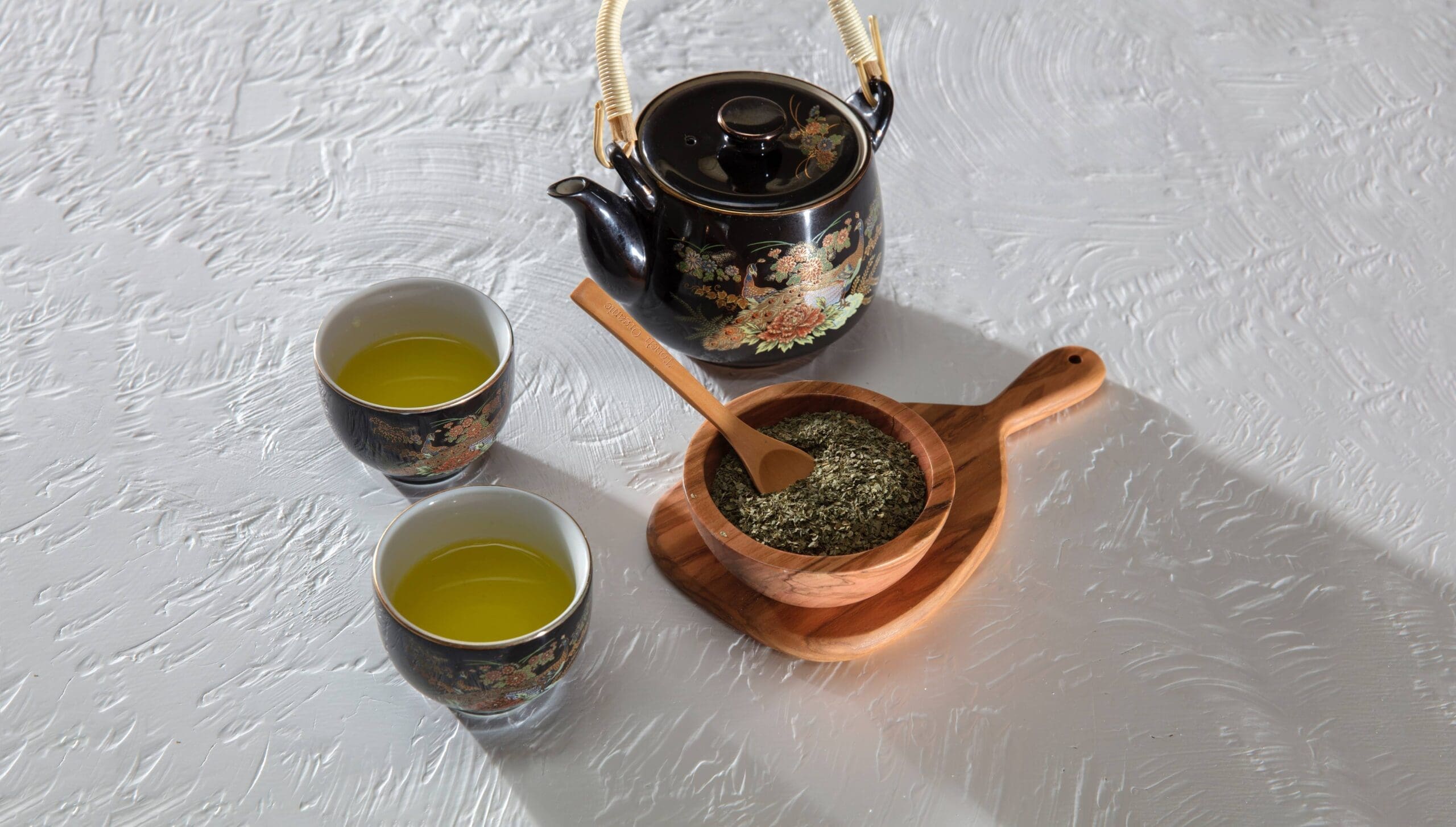 A Picture containing green tea, cups and kettle