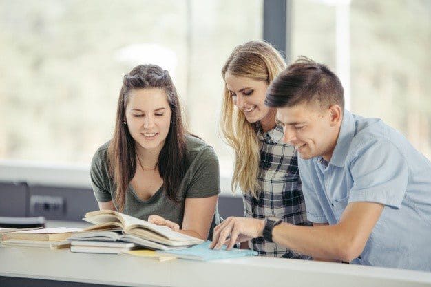 Boy and girls looking at books