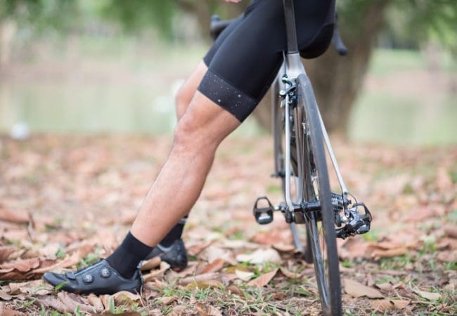 Young Man Cyclist Riding Mountain Bike In Public Park At Moring