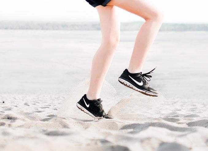 Woman Runner Legs On Sand
