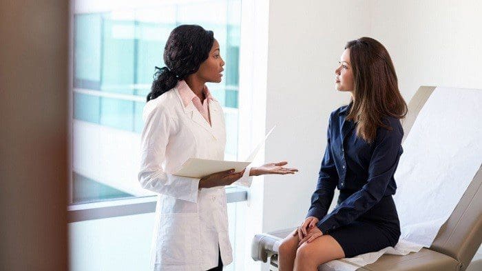 Woman Discussing With Doctor