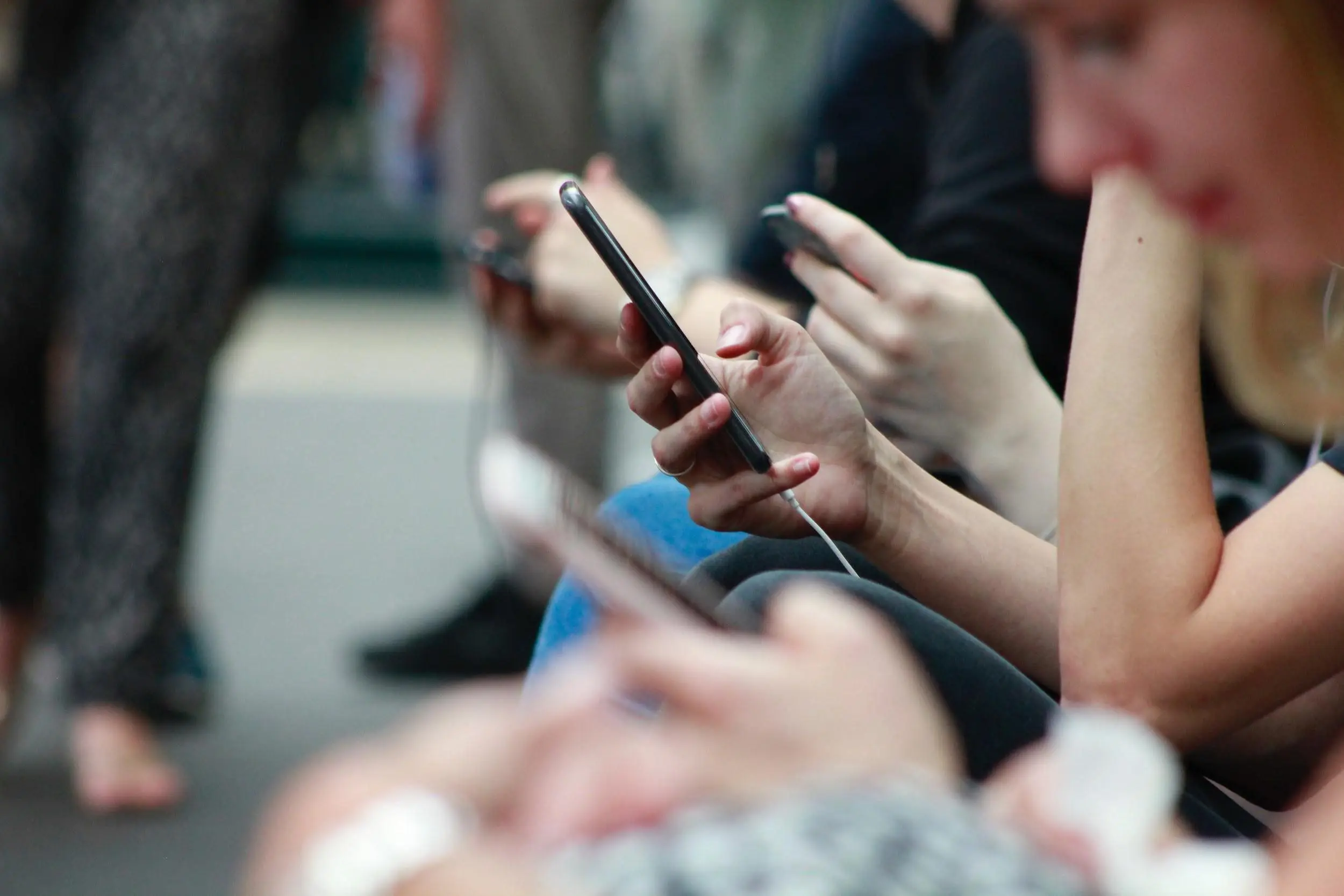 people looking at their mobile screens social media marketing