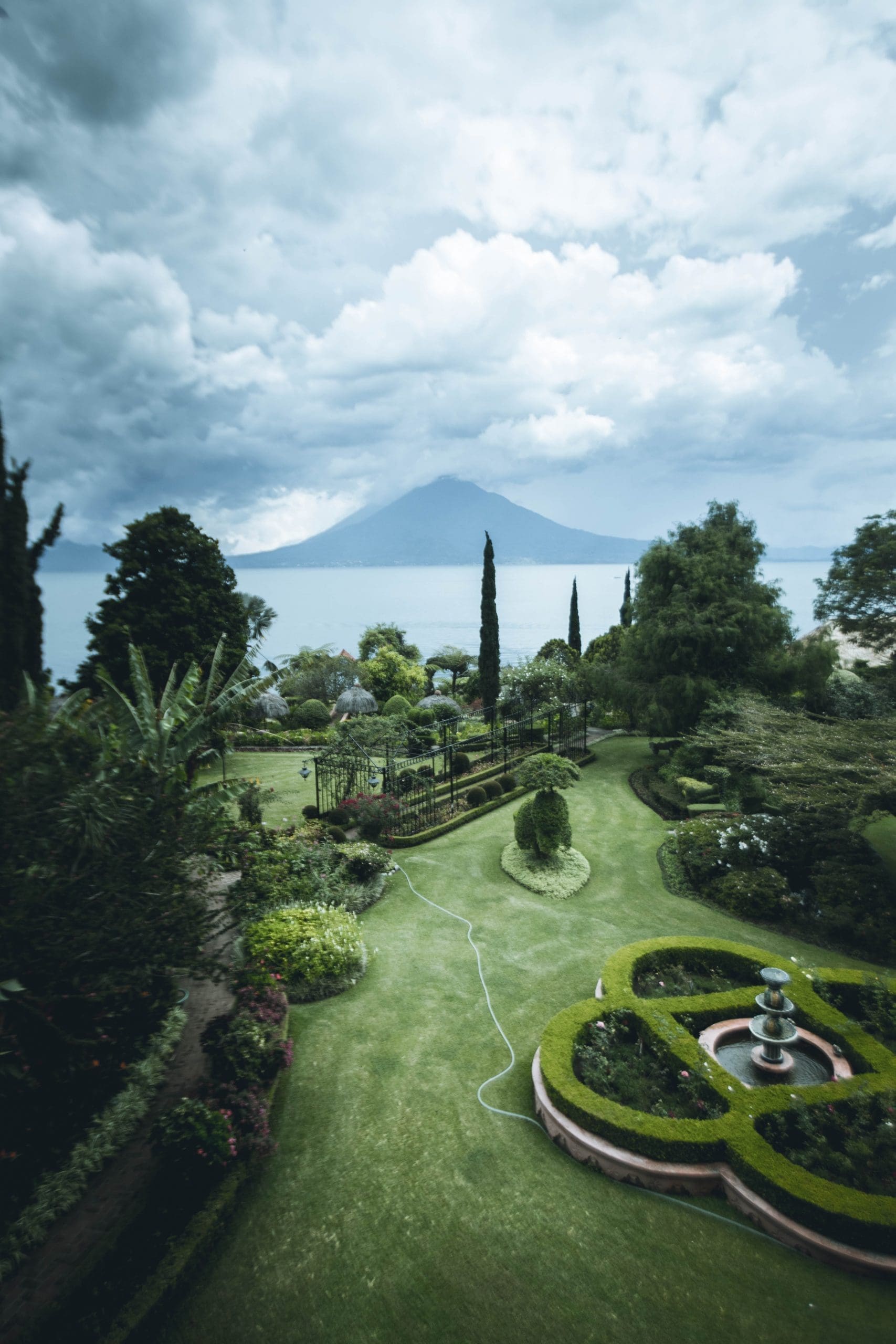 Photo by Roberto Nickson landscape gardening green flower garden viewing sea under white and blue skies