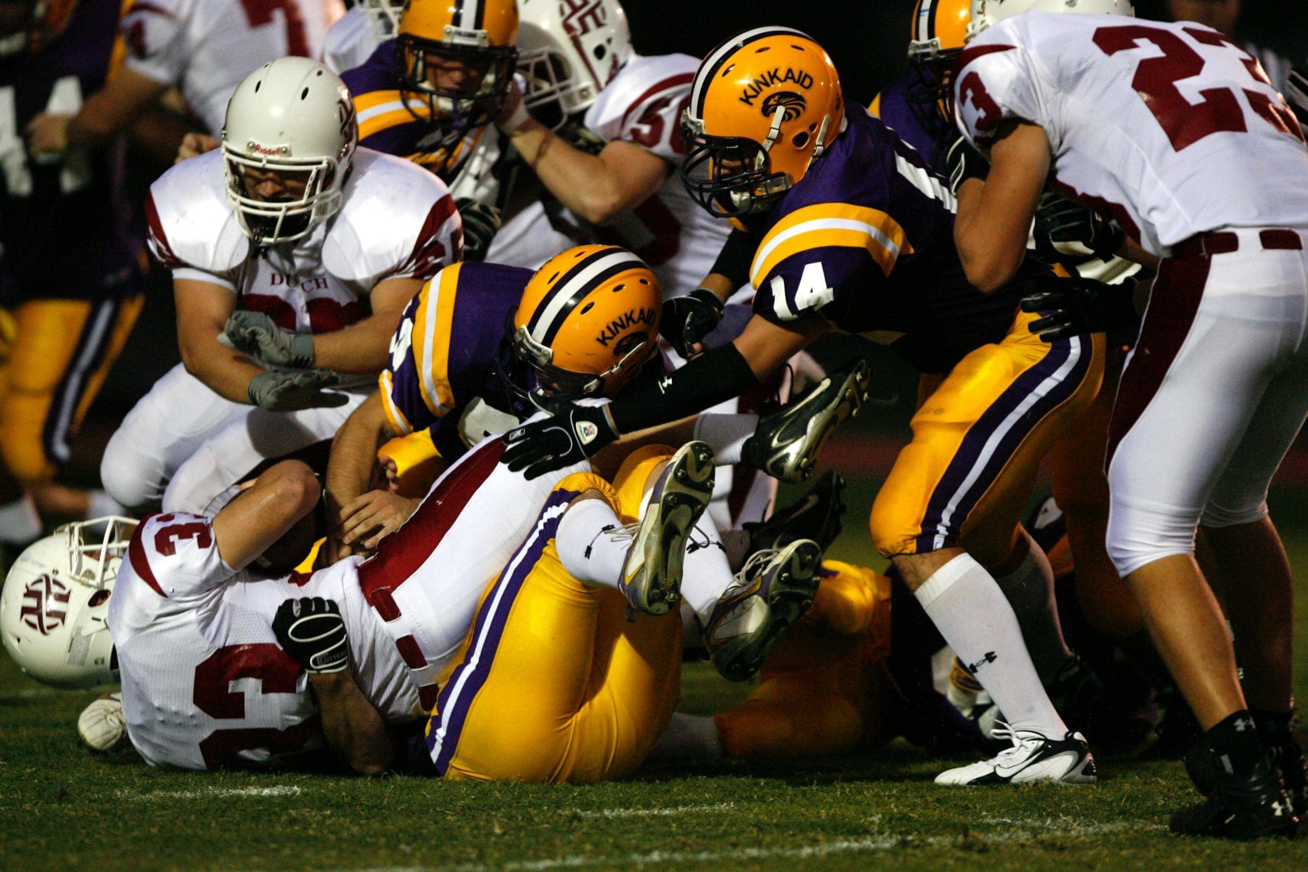 Photo by Keith Johnston football players tumbles on each other