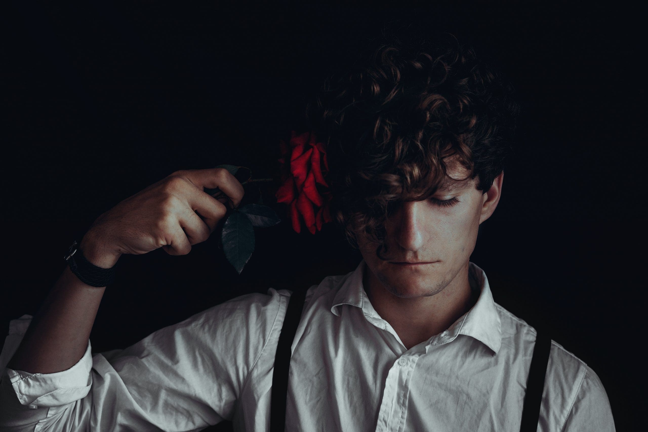 man in white dress shirt holds red flower i changed my mind