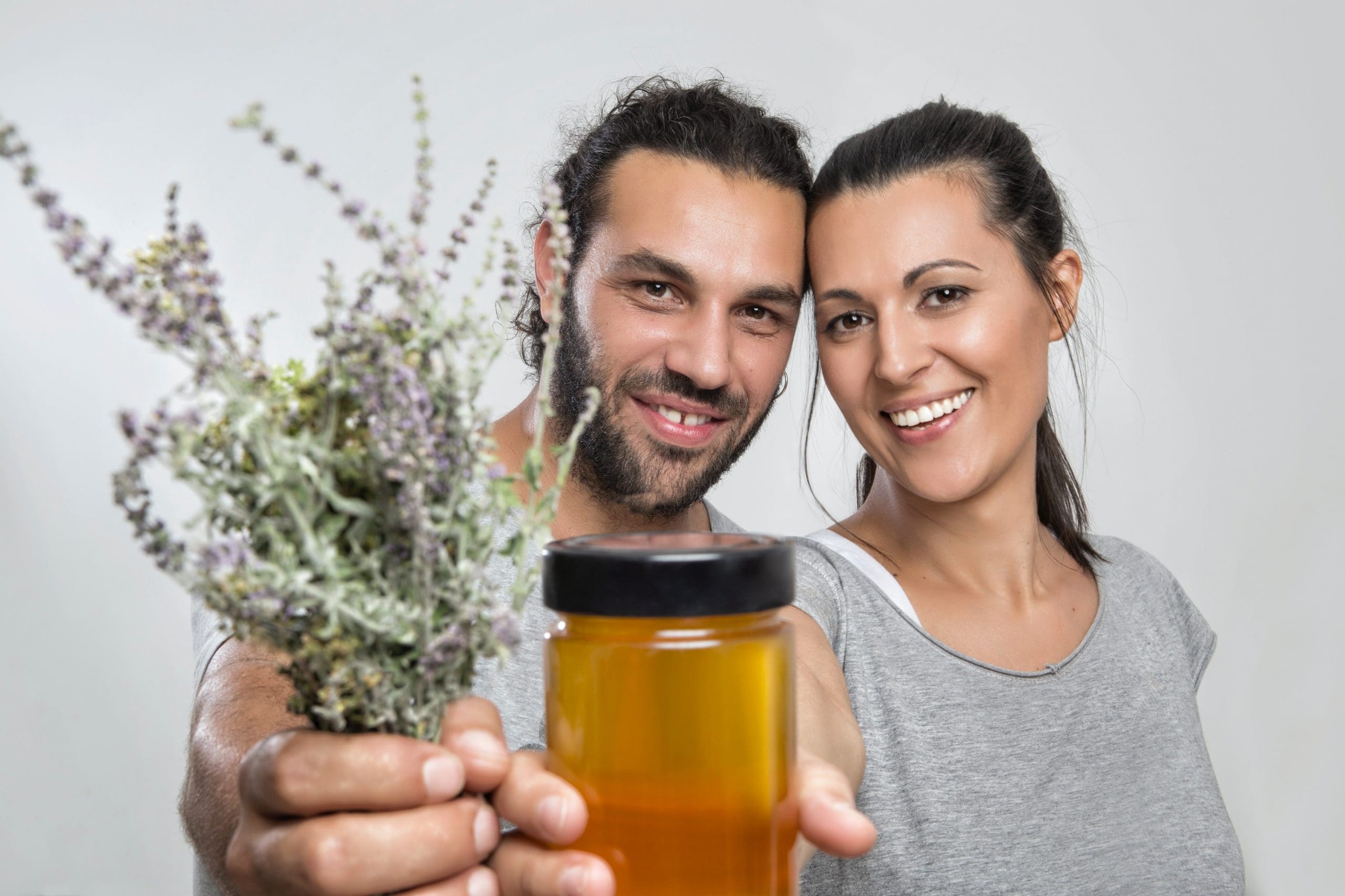 man and woman holding plants skin whitening