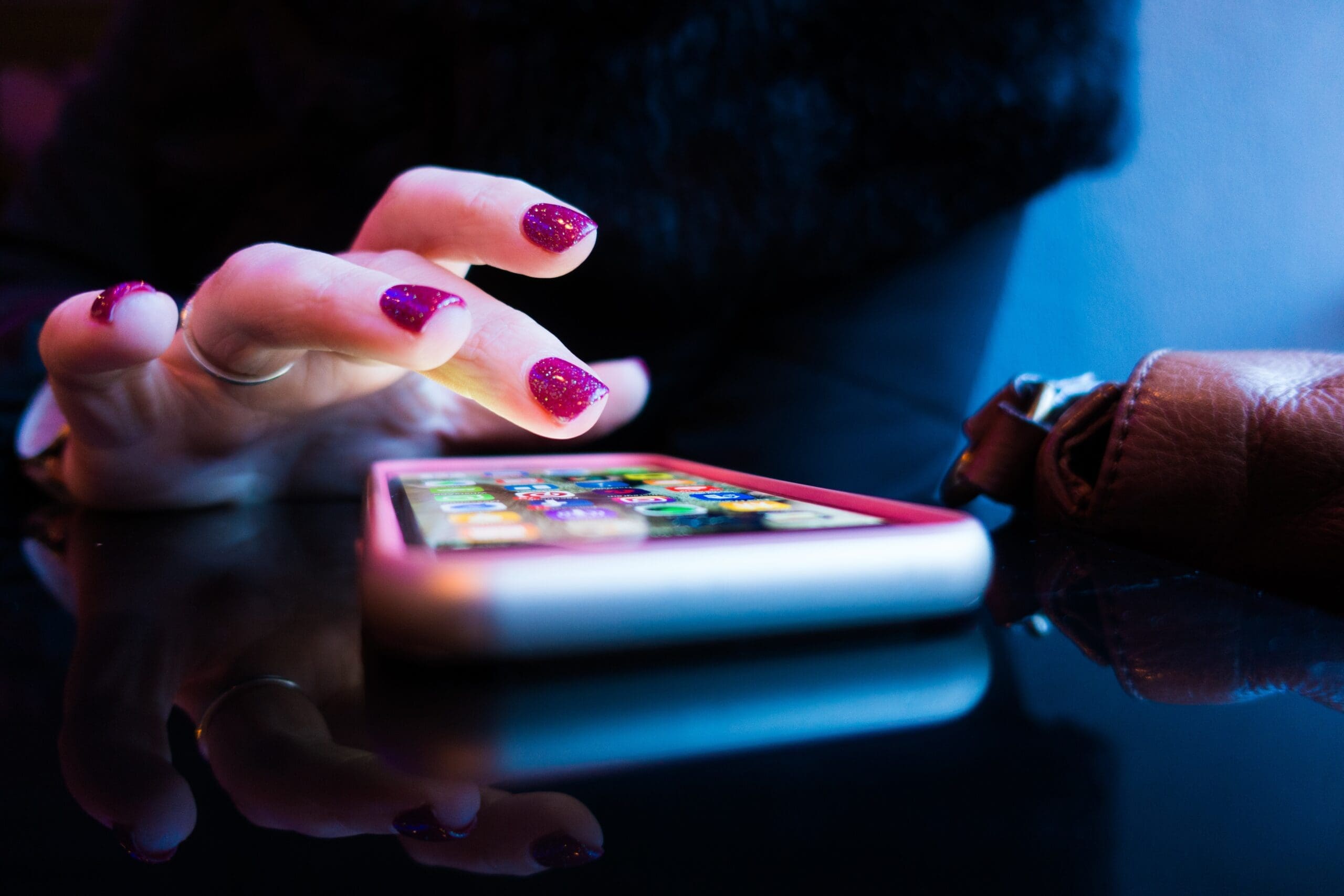 user person using black smartphone with gray and pink case