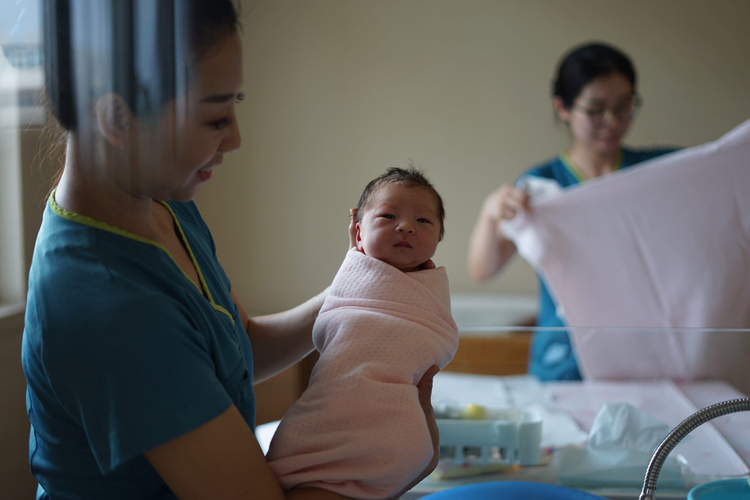 woman carrying newborn baby to be a nurse Nurse baby