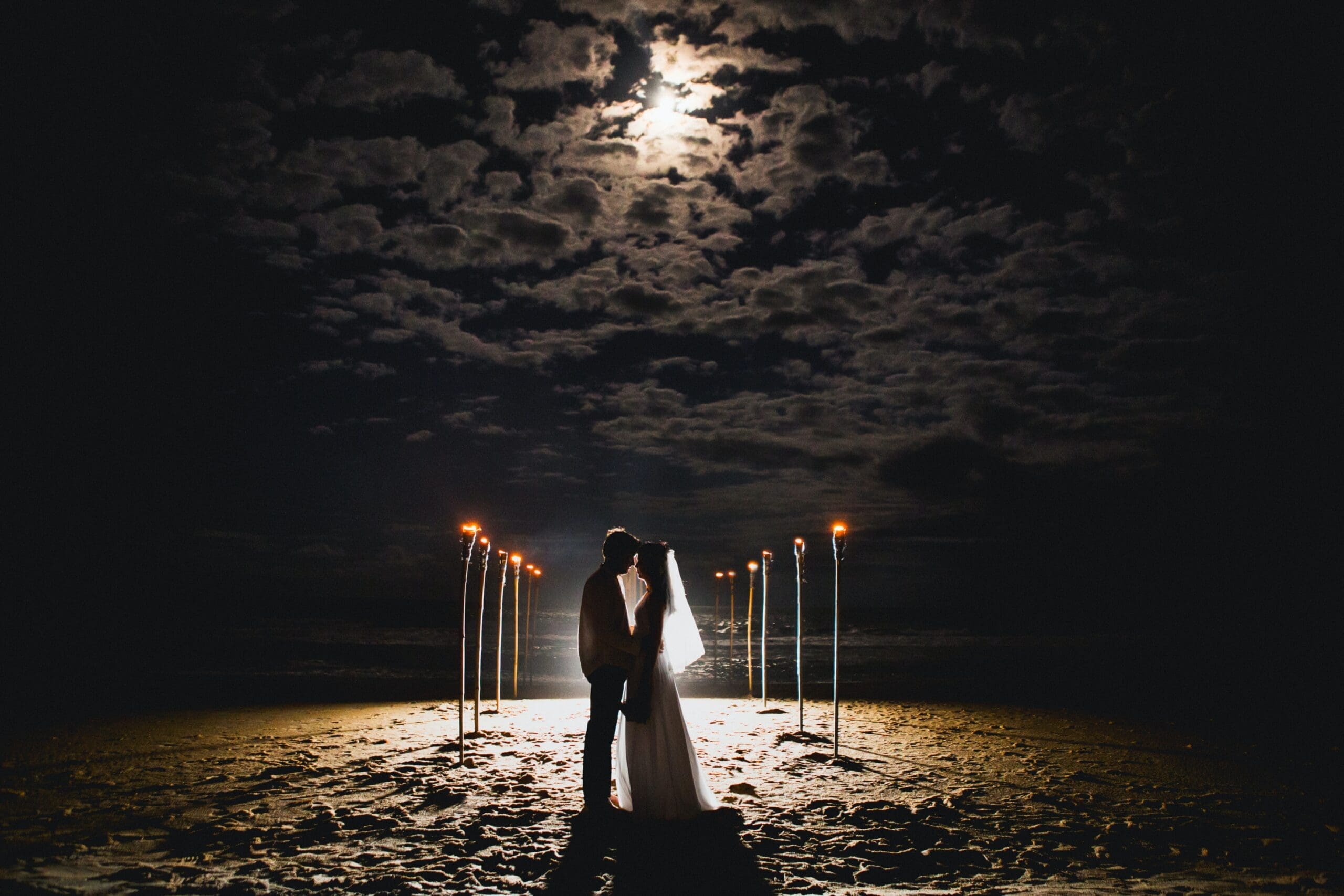 newly wed under grey sky beach wedding