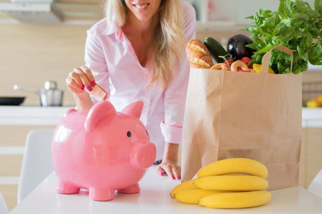 Woman saving money with smarter shopping piggy bank finances