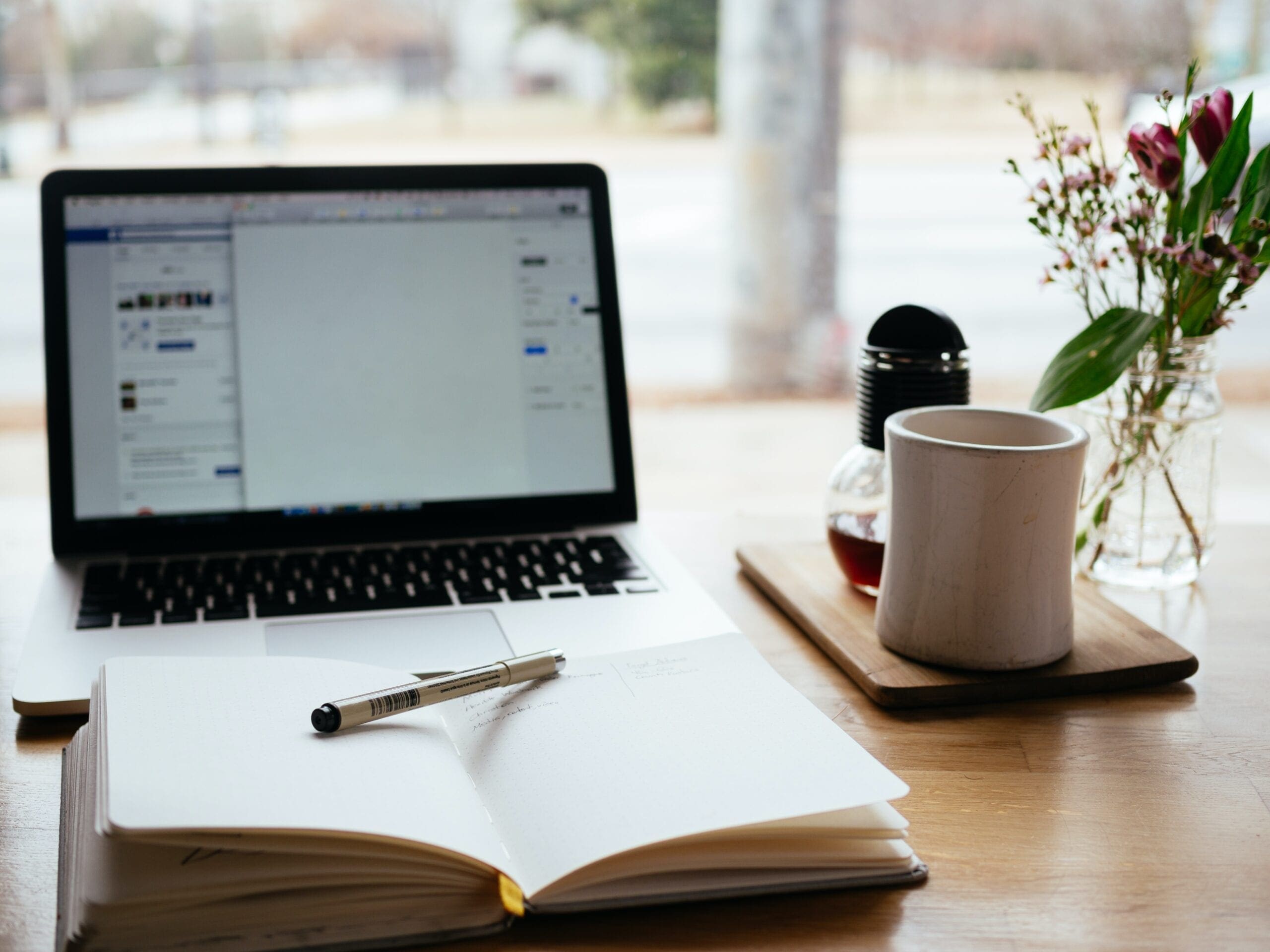 MacBook Pro near white open book online courses