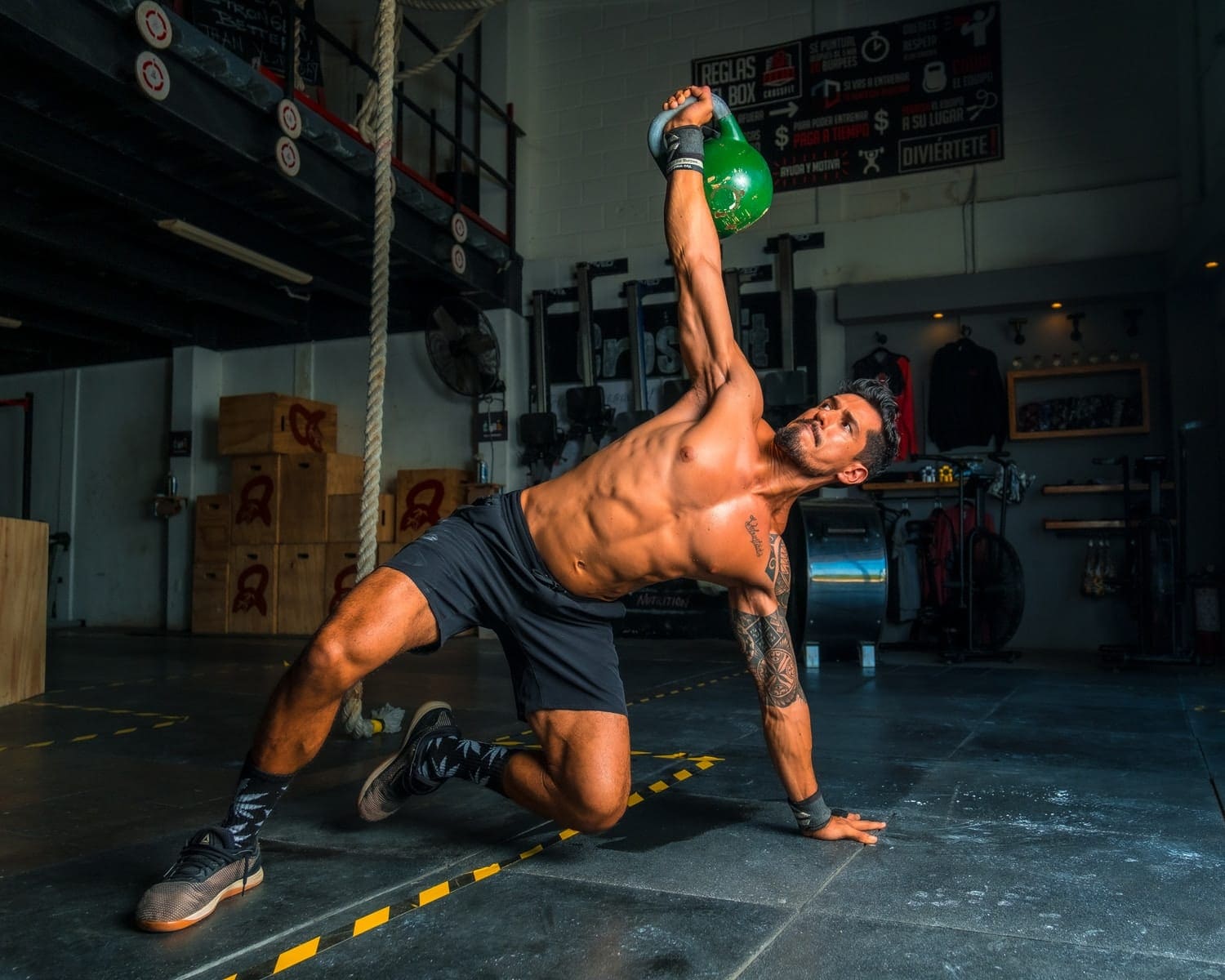man in black shorts and black tank top doing push up quarantine athlete