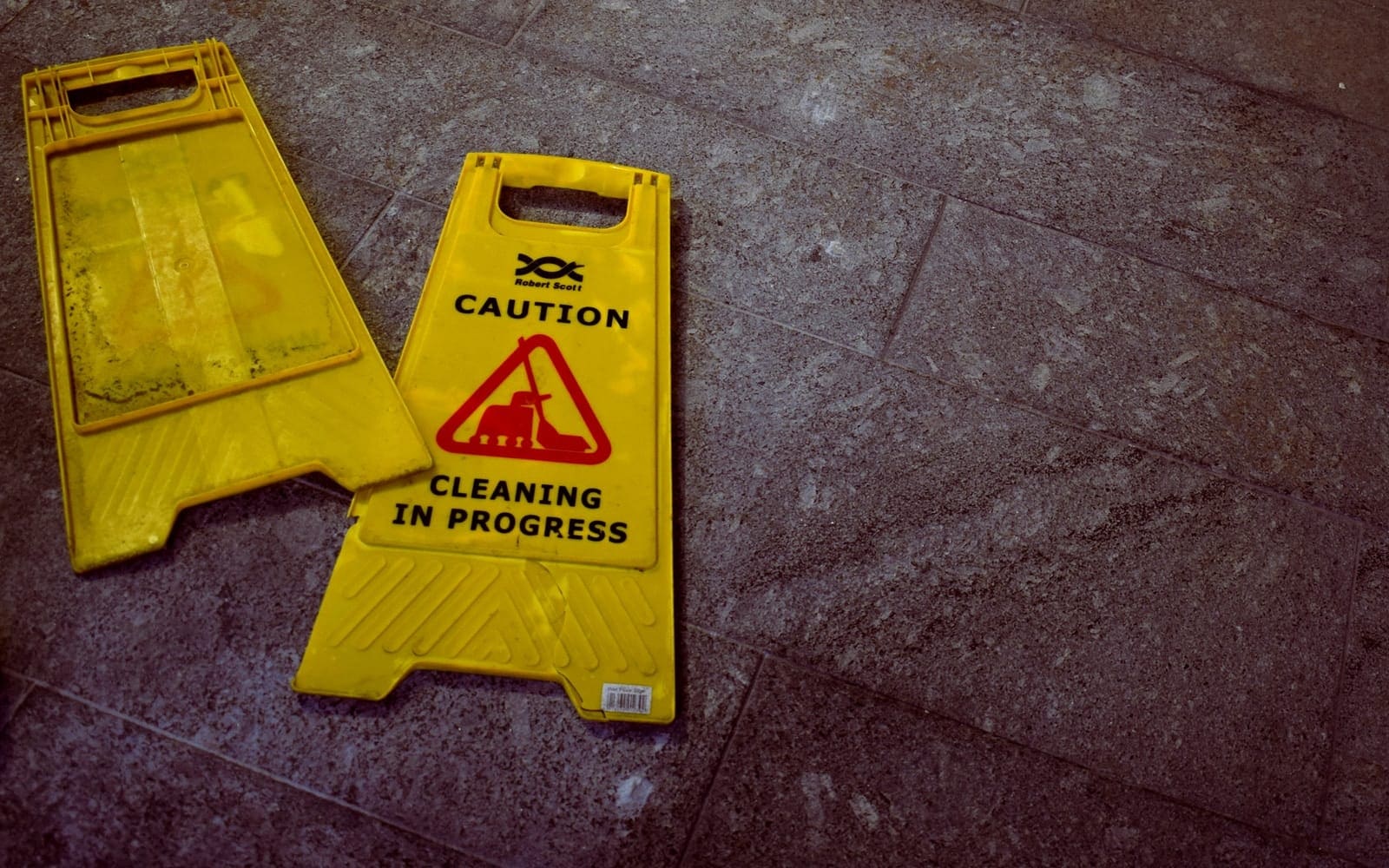 two Caution signages cleaning company