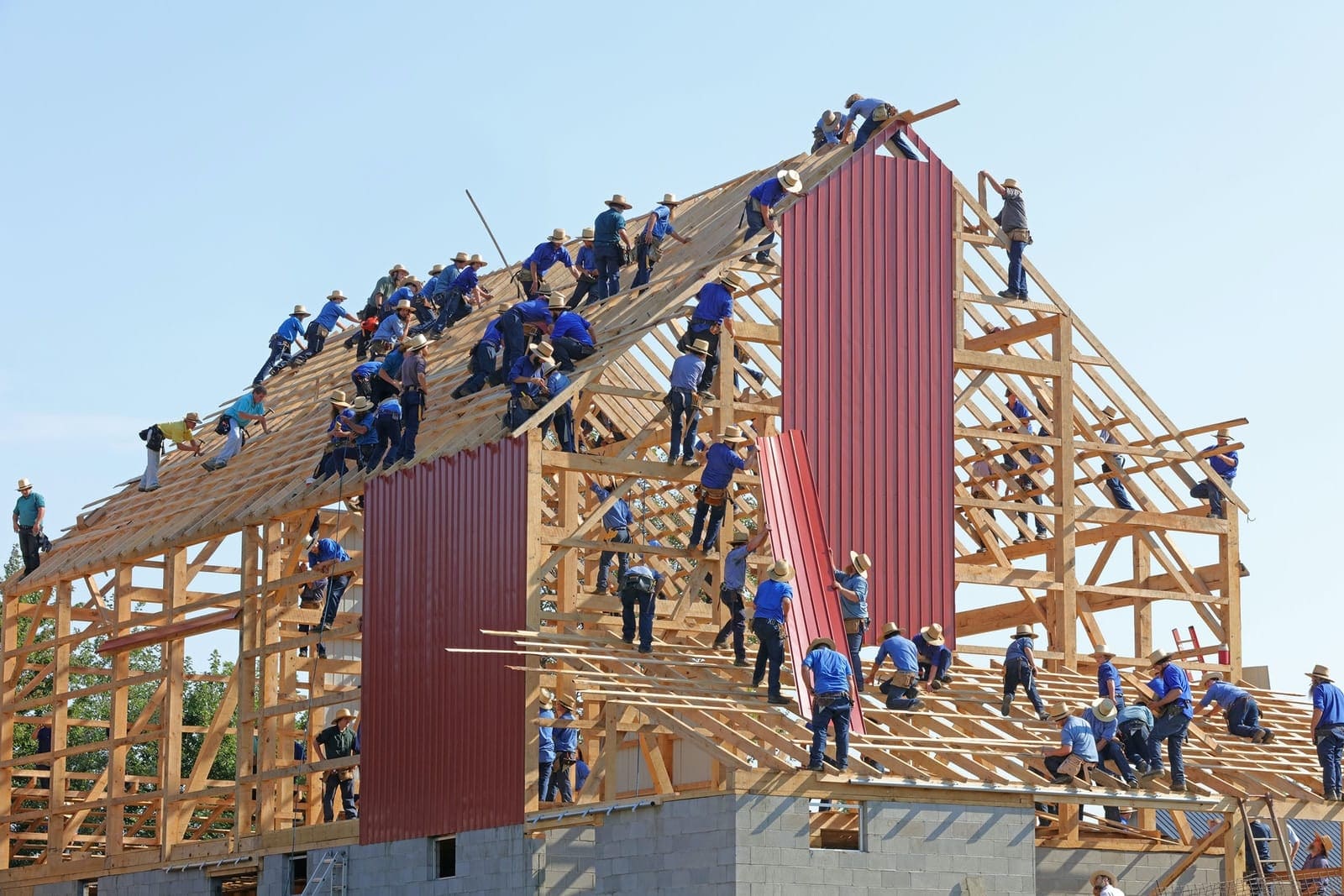 people building structure during daytime Working on heights equipment