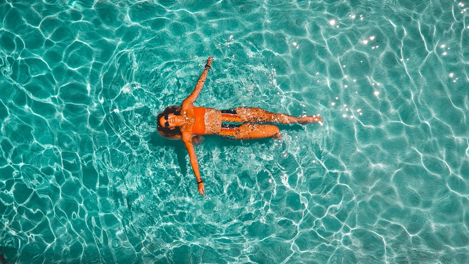 woman swimming alone in body of water swimming pool chemicals