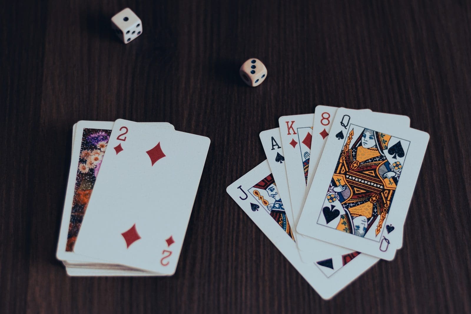 online poker playing cards on brown wooden table