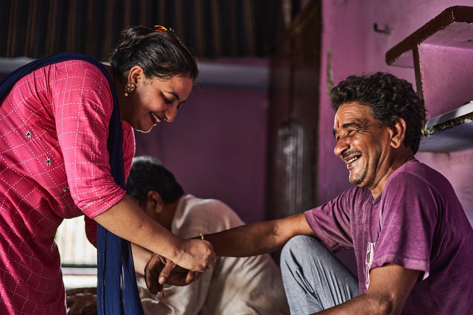 The Bandhan Of Rakhi 2 man in purple shirt and gray pants sitting on floor