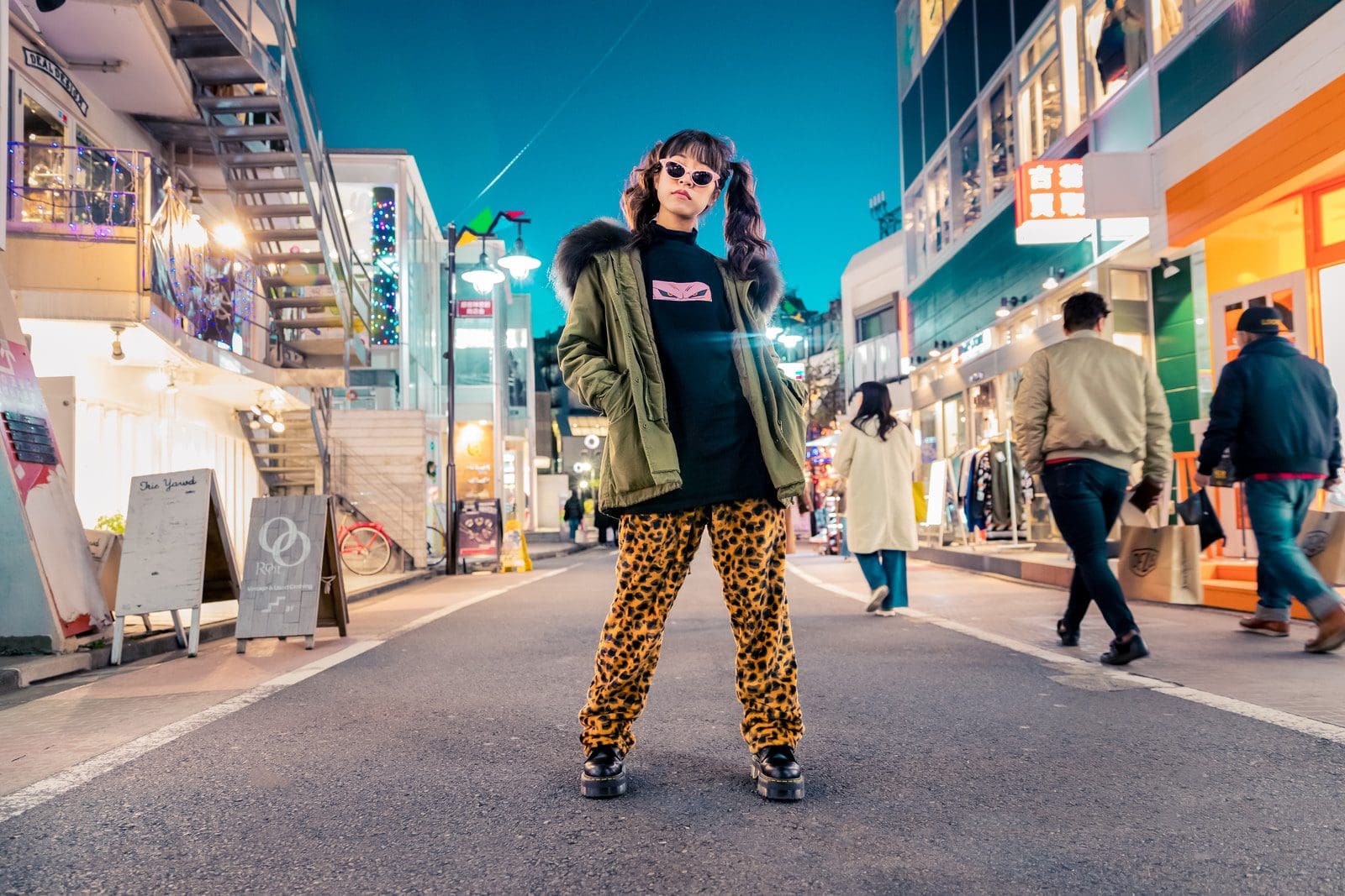Photo by Joshua Chun Sense of Style woman in green jacket stands and pose on street