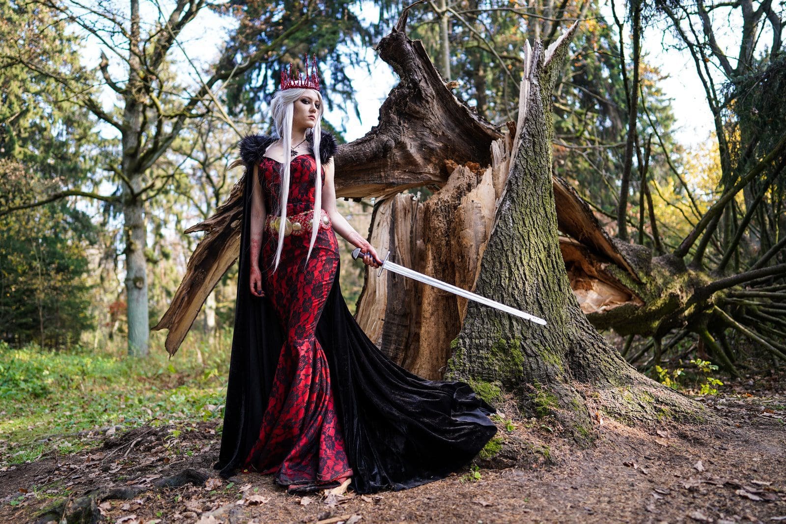 Photo by Dmitry Vechorko woman wearing red dress holding sword