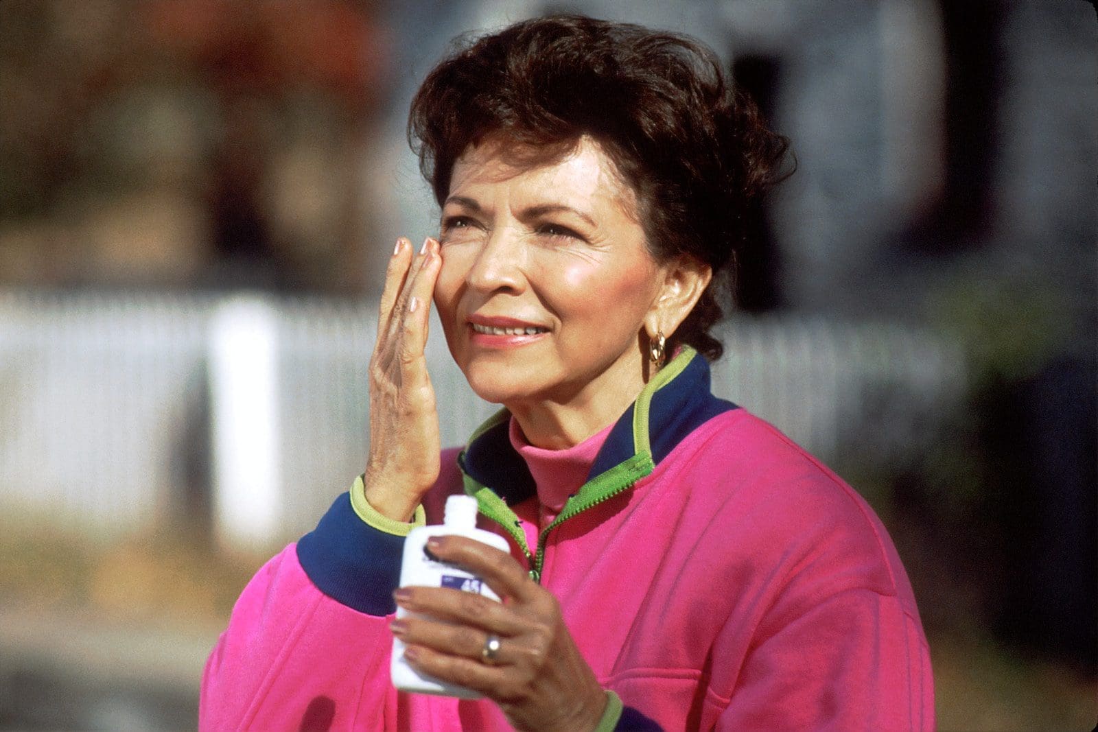 eyes look younger smiling woman in pink and blue shirt