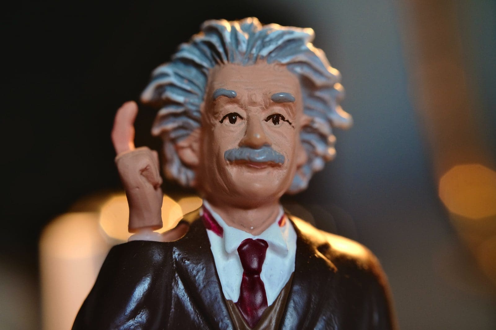 learn physics man in black suit jacket figurine