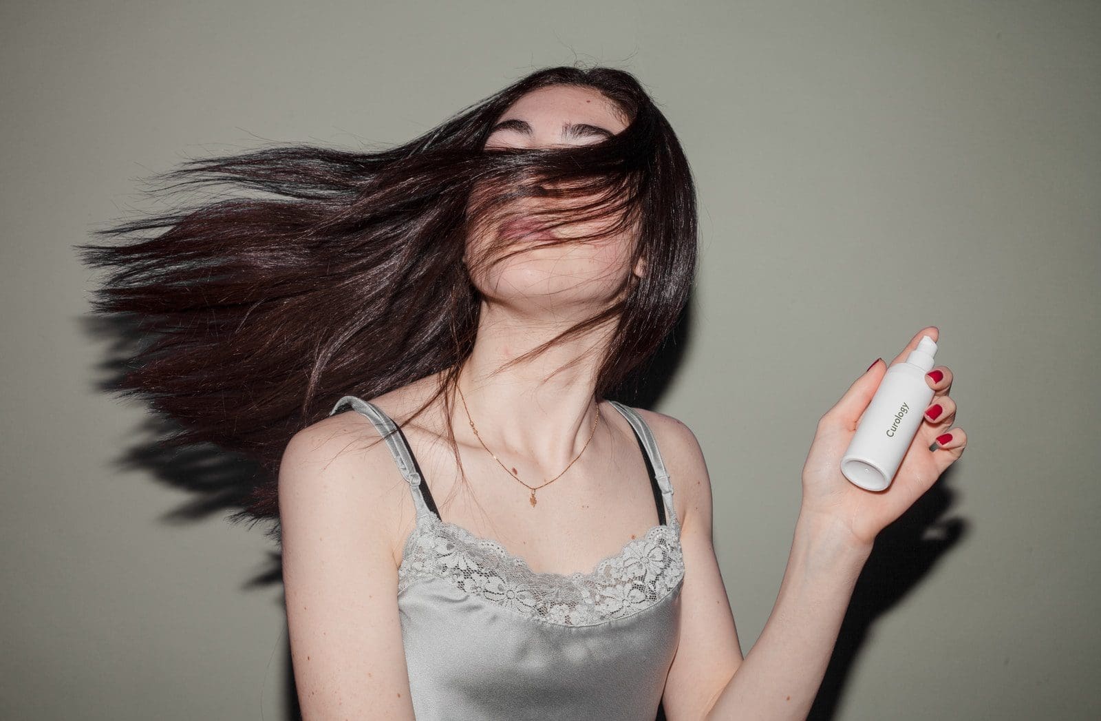 strong hair roots woman holding spray bottle
