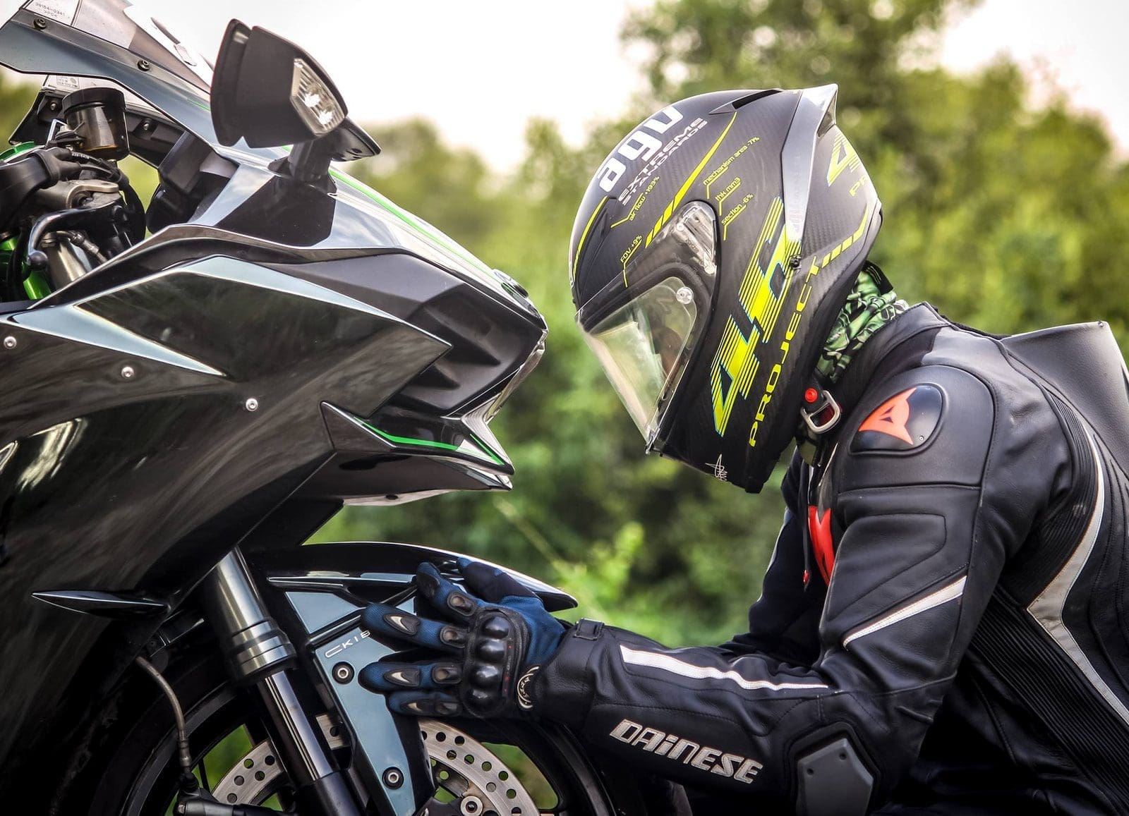 motorbike accessories person wearing helmet while holding motorcycle