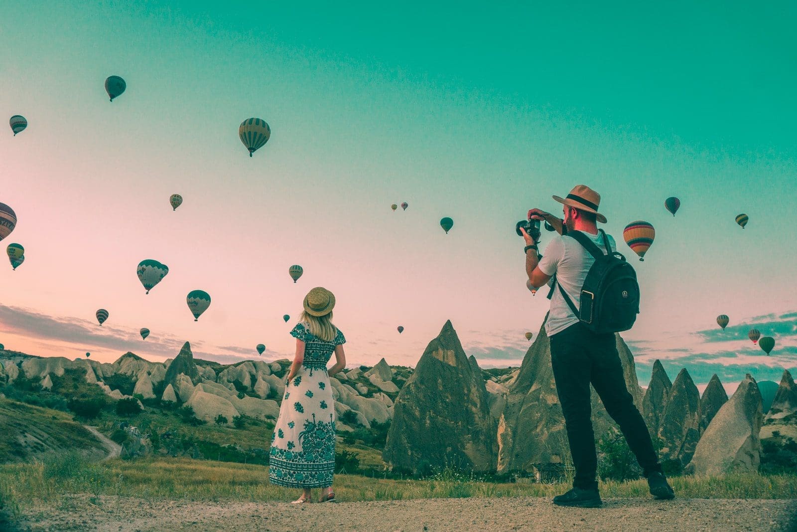 travel blogger man taking photo of hot air balloons
