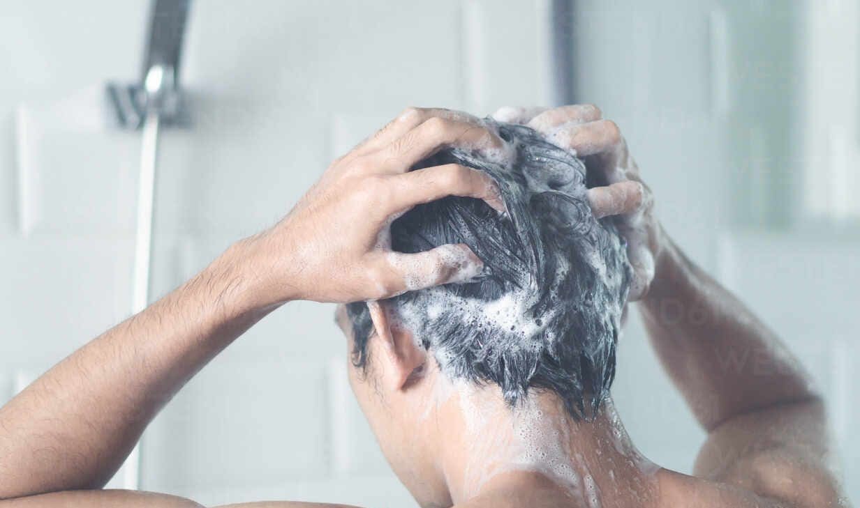 man washing hair in bathroom EYF05710 e1645810777776