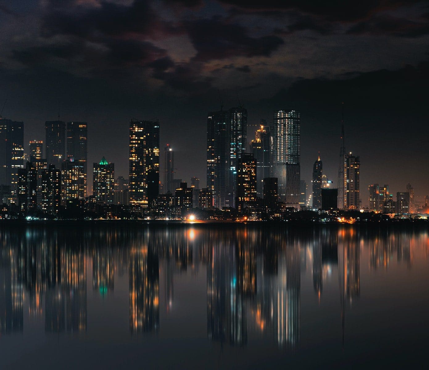 maharashtra companies City Skyline Across Body of Water during Night Time