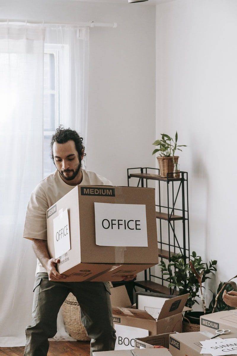 office Man Carrying A Box With Office Sign