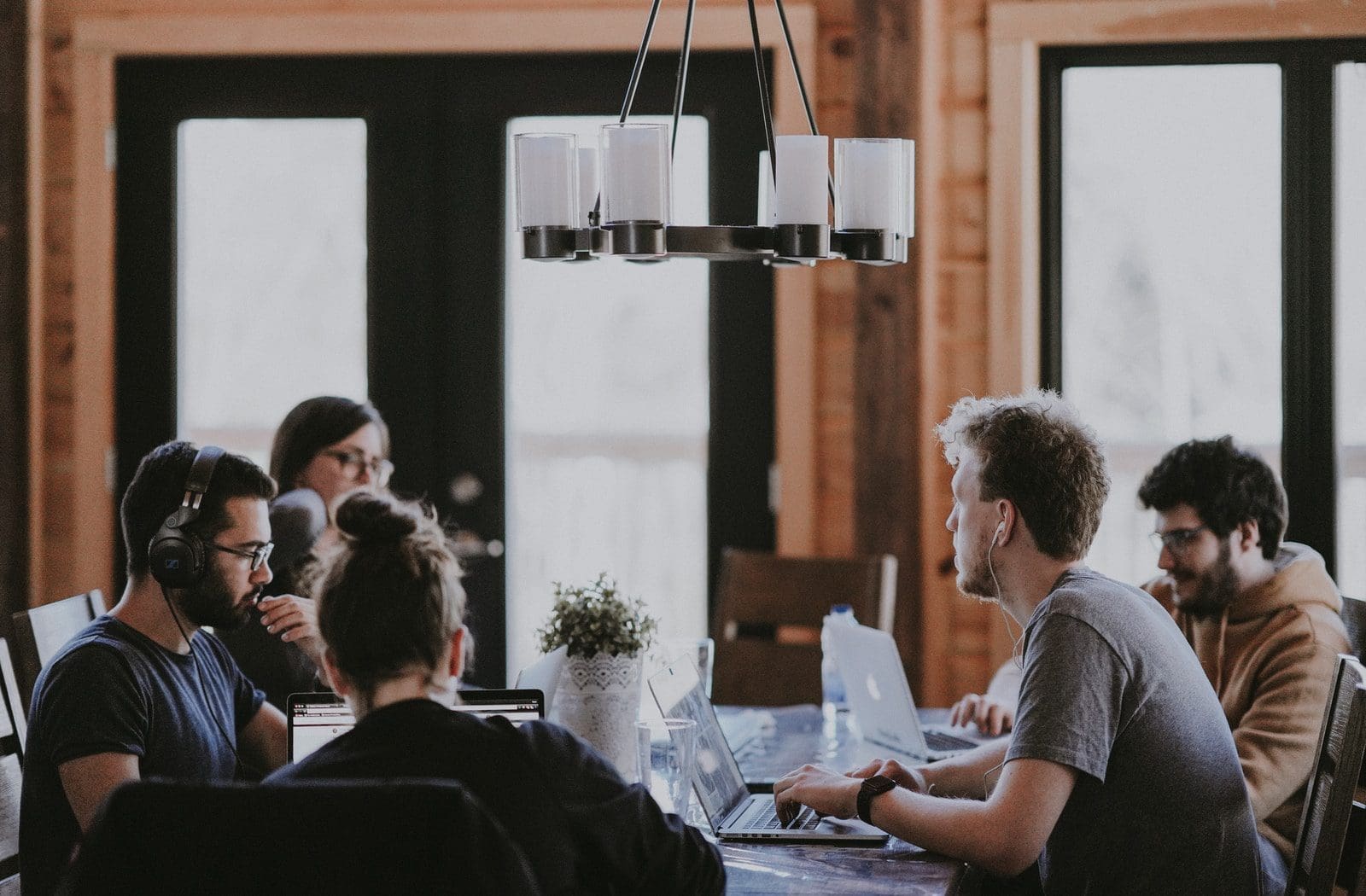 toxic work environment sittin people beside table inside room