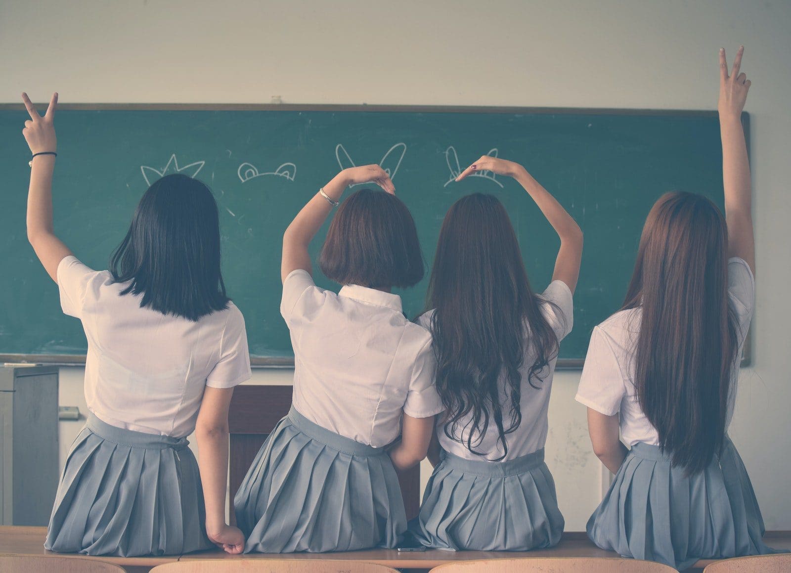 Photo of Four Girls Wearing School Uniform Doing Hand Signs hair extensions