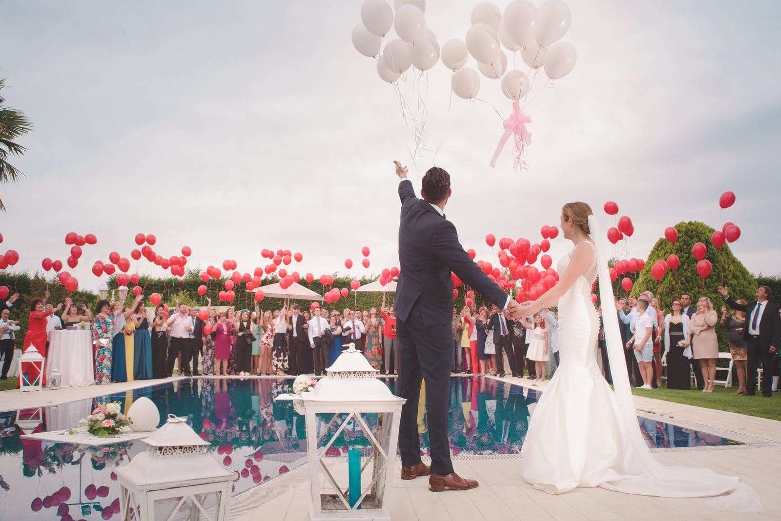 photo of a man and woman newly wedding holding a balloons at wedding