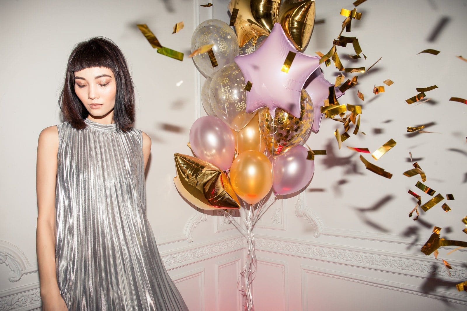 Woman Wearing Pleated Silver Dress at party