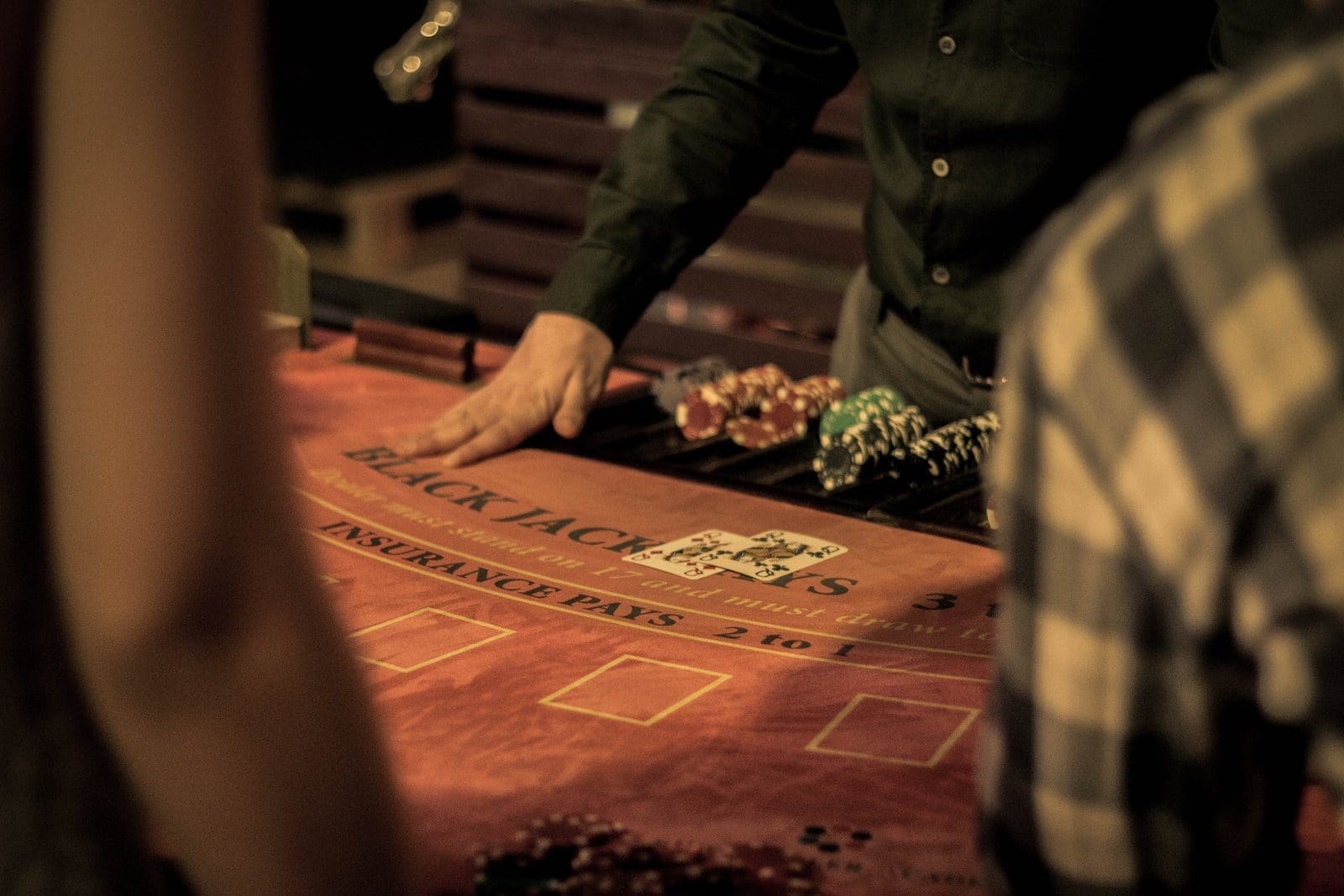 casino myth man in green dress shirt sitting on chair