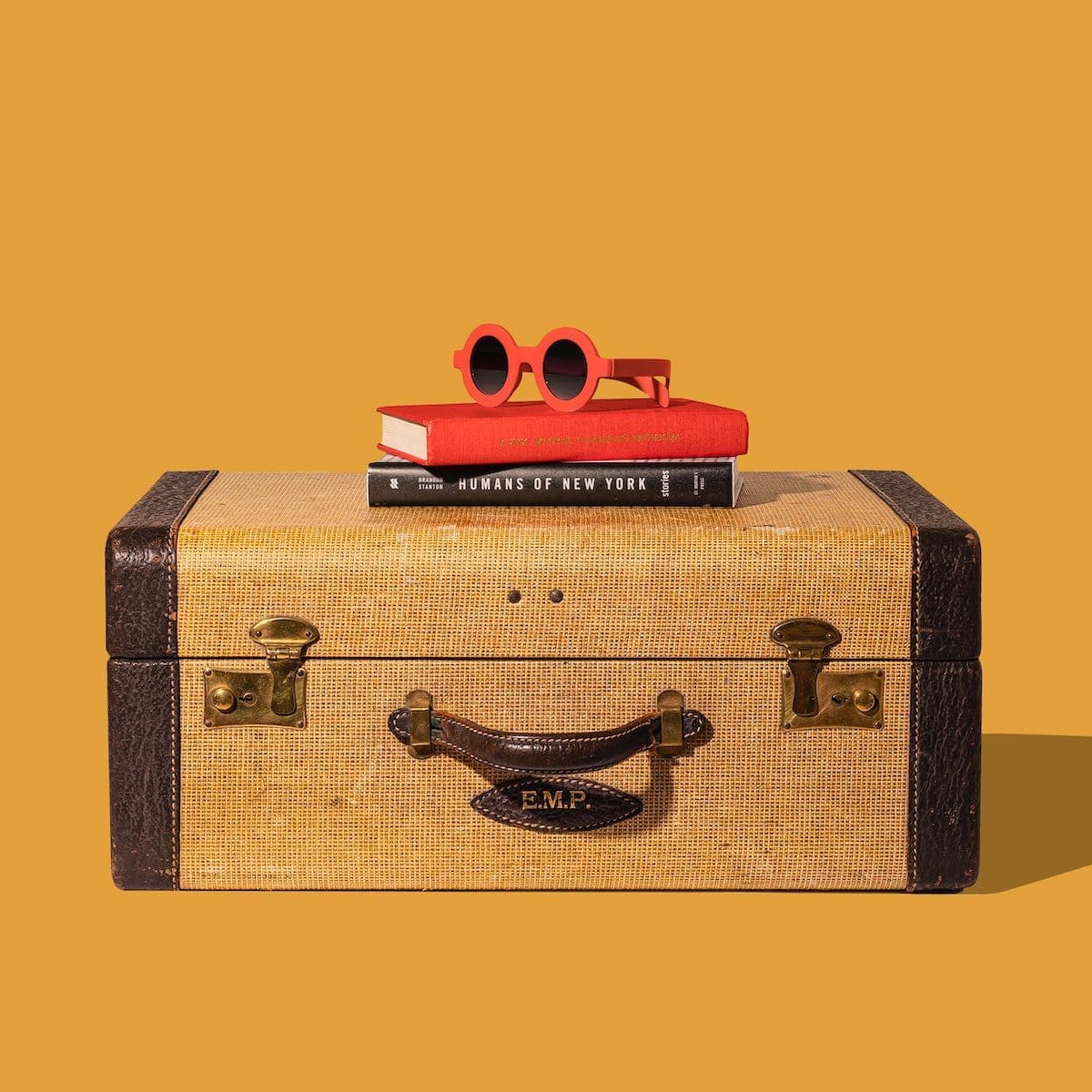 brown and black suitcase with red and yellow plastic toy