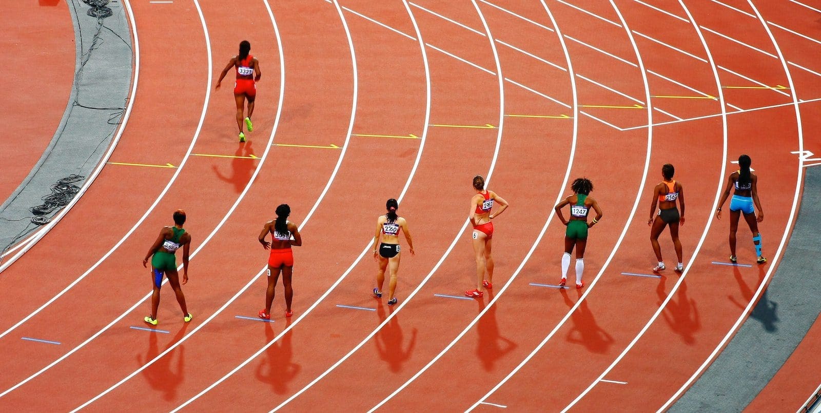 women running on race track during daytime