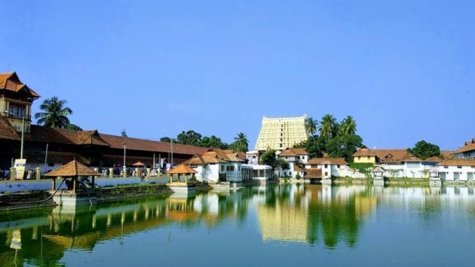 brown-and-white concrete building near body of water during daytime house in trivandrum