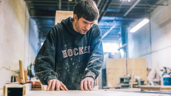 Photo by Harrison Haines Man on Cutting Table vocational training