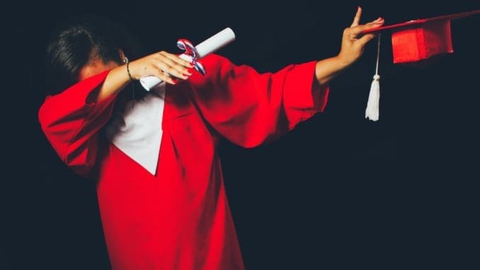 person wearing red graduation dress college degree