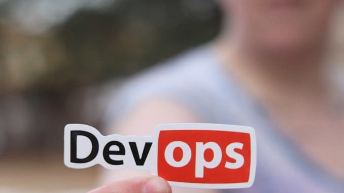 Person Holding a Sticker DevOps