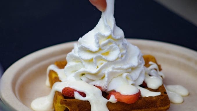 Photo by Andrew Lancaster white icing on brown cake Whipped cream