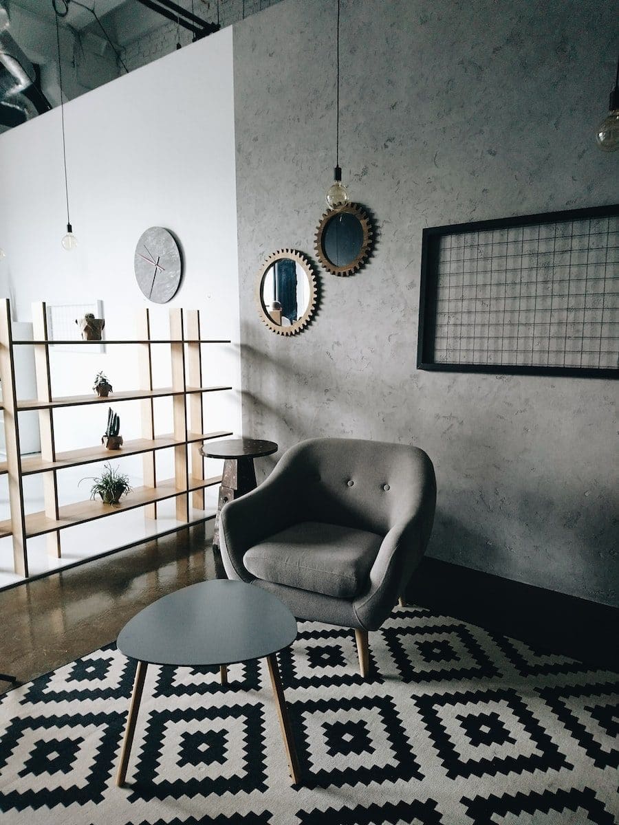 gray padded couch in front of wooden center table ideal flooring